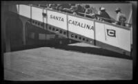 Passengers walk up a gangplank to board a ship, Avalon, 1948