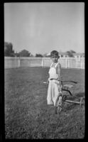 Billy Burgess poses with his tricycle in his backyard, Bell Gardens, 1948