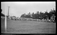 Spectators sit around a contest field during the Trailer Coach Association of California's rally, Ventura, 1948
