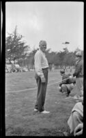 Bert O'Hanlon, of Westcraft, stands in a field during the Trailer Coach Association of California rally, Ventura, 1948