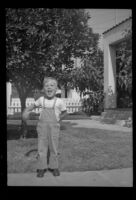 Tommy Newquist stands in a yard, Los Angeles, 1948