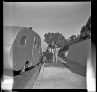 Mertie West, with Agnes and Forrest Whitaker outside the Whitaker's home beside a Main Line Silver Lark trailer, Los Angeles, 1948