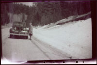 Mertie West beside a roadside snow bank in Kaibab National Forest, 1942