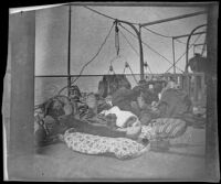 Group of five male ferry passengers resting on mattresses, Turkey, 1895