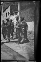 Five men on a sidewalk in front of a building, Turkey, 1895