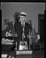 Detective Emmet Jones with pistol trophies, Los Angeles, 1936