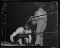 Gege Gravante kneels over the ropes during a fight against Roy Johnson, Los Angeles, 1936