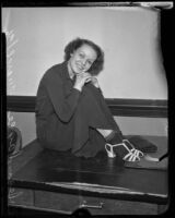 Jean Joyce seated on a desk, Los Angeles, 1936