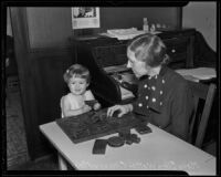 Eleanor Magnussen and Mary Ellen Watts play a puzzle game at the Mothers' Educational Center, Los Angeles, 1936