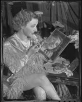 Circus performer Marian Darling applies lipstick, Los Angeles, 1936
