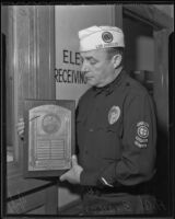 Adolph C. Brauer, ambulance driver, holds an American Legion award, Los Angeles, 1936