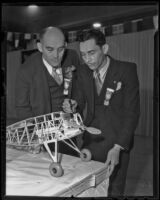 A. Milton Fish, left, and Bert R. Hall, stand by a model plane, Long Beach, 1936