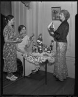 Mrs. Howard Liner, Jeane Langhorst Gould and Mayes Donoho admire dolls, Los Angeles, 1936