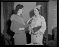 Marjorie Stevens pins a badge on Grace Mortensen, Los Angeles, 1930s