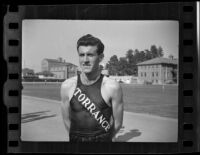 Louis Zamperini standing on Bovard Field, University of Southern California, Los Angeles, 1938