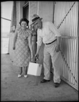 Carl M. Einhart and Mrs. Parkman Burritt carry a block of dry ice, Niland, 1936
