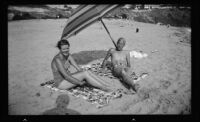 Mr. and Mrs. John Swanson sunbathe at Emerald Bay, Laguna Beach, 1936