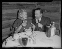 Jean Rogers, actress, and Juan Govi at a restaurant, Los Angeles, 1936