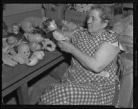 Goodwill worker repairing dolls, Los Angeles, 1938