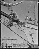 R.L. Yates sits atop a bowsprit, Newport Beach, 1938-1939