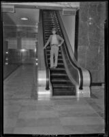 E. A. Stuhr uses a Federal Building escalator, Los Angeles, 1939