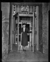 Mary Briggs, postmaster, enters the post office in the new Federal Building, Los Angeles, 1939