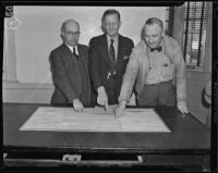 Frank L. Perry, Mayor Colfax Bell and D. L. Bundy pose with plans for the proposed Redondo Beach breakwater, Redondo Beach, 1938