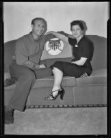 Charley "Red" Ruffing, New York Yankees pitcher, and his wife, Pauline Ruffing, seated on their sofa, Long Beach, 1939