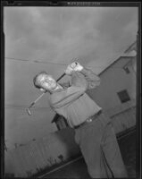 Charley "Red" Ruffing, New York Yankees pitcher, practicing his golf swing, Long Beach, 1939