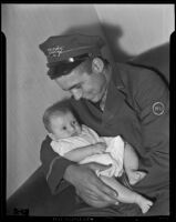 Western Union messenger John Gross tends to baby Barbara Louise Lawrence, Los Angeles vicinity, 1938