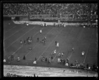 Stanford player runs with the football up the sideline during the Rose Bowl game against Columbia, Pasadena, circa 1934