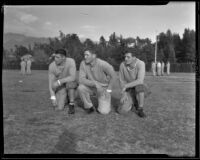 Three Stanford football players pose during practice, Pasadena, circa 1934