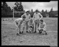 Claude E. Thornhill, Stanford football coach, poses with his players during practice, Pasadena, circa 1934