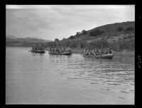 Thirty Marines row across a lake in 3 rafts during a training exercise, Camp Pendleton, circa 1943