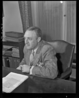 Elbert S. Conner, secretary and manager of the Santa Barbara County Chamber of Commerce, seated and leaning forward, Santa Barbara, 1946