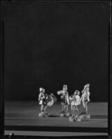 Four carved wooden musicians photographed for the F. E. Olds and Son musical instrument company, Los Angeles, 1933 to 1939