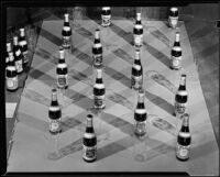 Bottles of Mission Dry Sparkling fruit beverage and drinking glasses, Los Angeles, circa 1930