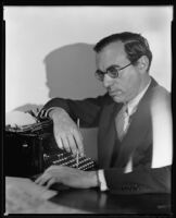 Lew Levenson, writer, seated with a typewriter, circa 1933