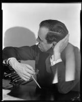 Lew Levenson, writer, seated with a typewriter, circa 1933