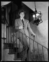 Fred Keating, actor, on a stairway in his Hollywood Hills house "Casa Escrow," Los Angeles, circa 1934