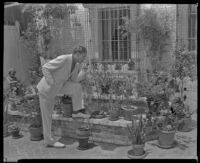 Ralph Bellamy, actor, in resort attire smoking a pipe, perhaps in Palm Springs, circa 1933