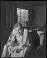 Ralph Bellamy, actor, seated on a chair, perhaps at home, 1932-1939