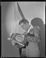 Man reading Esquire magazine, circa 1926-1939