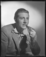 Man smoking a pipe, circa 1926-1939
