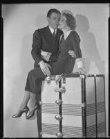 Nancy Carroll, actress, posing with a man, circa 1933-1935