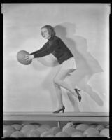 Inez Courtney, actress, preparing to throw a ball, circa 1934-1939