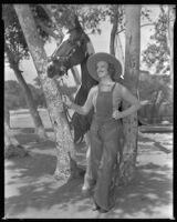 Inez Courtney, actress, holding the reins of a horse, circa 1934-1939