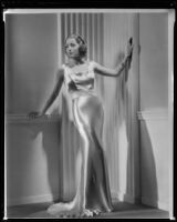 Joan Perry, actress, modeling a gown, circa 1935-1939