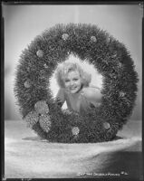 Barbara Pepper, actress, looking through a wreath, circa 1938-1939