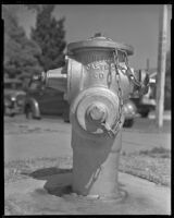 Fire hydrant with cars and trees in the background, circa 1926-1939
